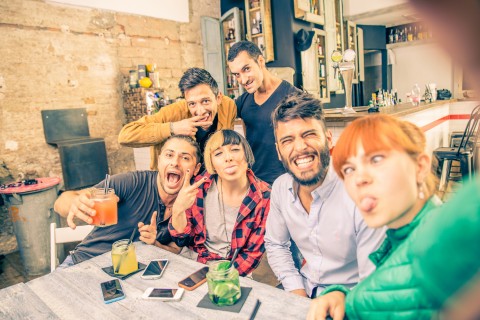 Group of friends having fun in a cocktail bar and taking a selfie - Young students partying together and taking picture - Concepts about fun,youth,technologies and nightlife