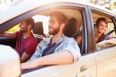 Group Of Friends In Car On Road Trip Together