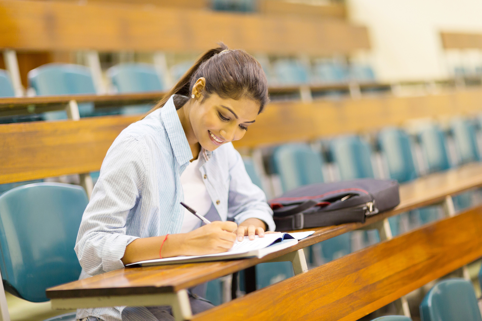 happy university student studying in lecture room